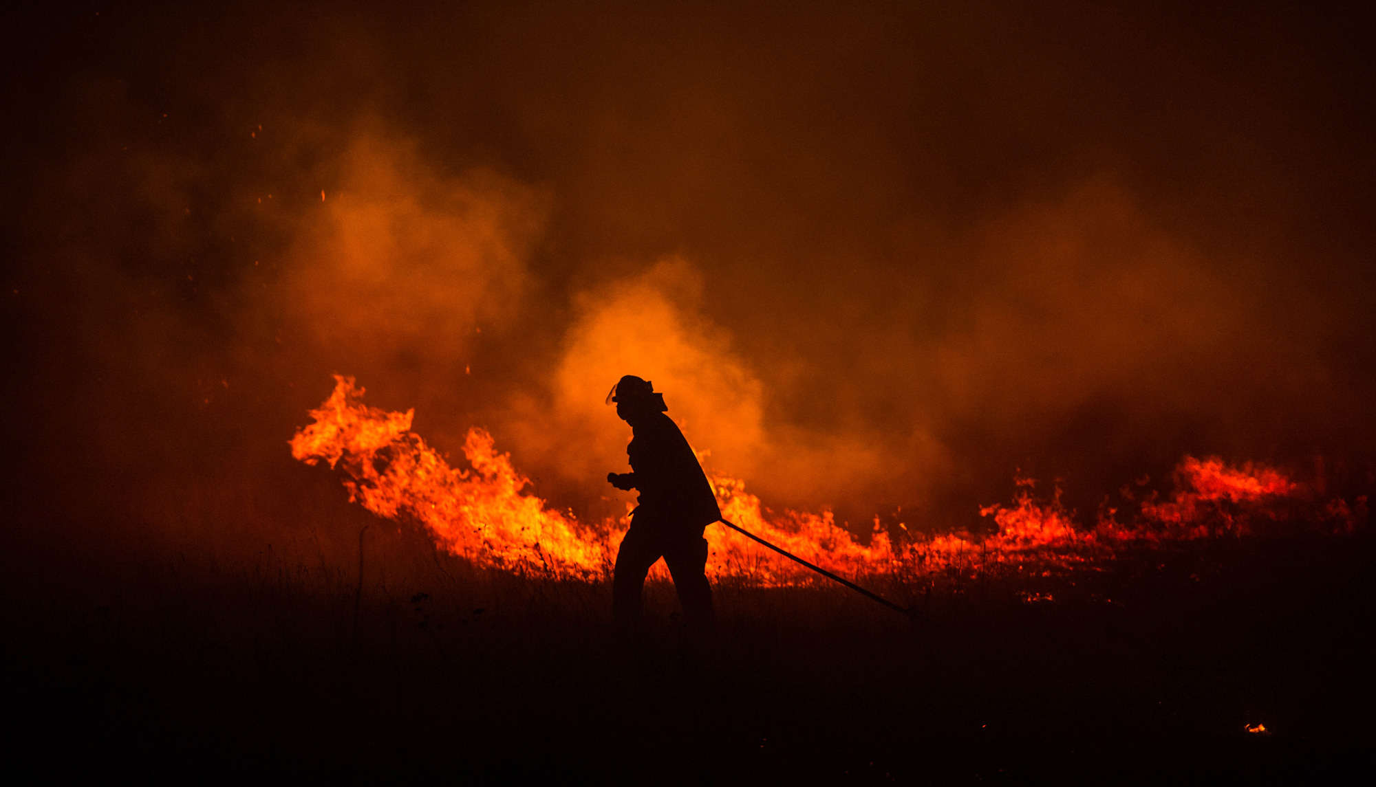 A firefighter strides through the Hunter Valley flames