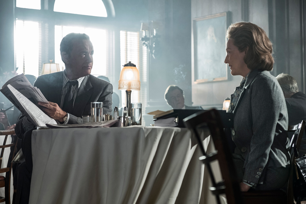 Ben Bradlee (Tom Hanks) and Kay Graham (Meryl Streep) sit opposite each other in a smokey restaurant.
