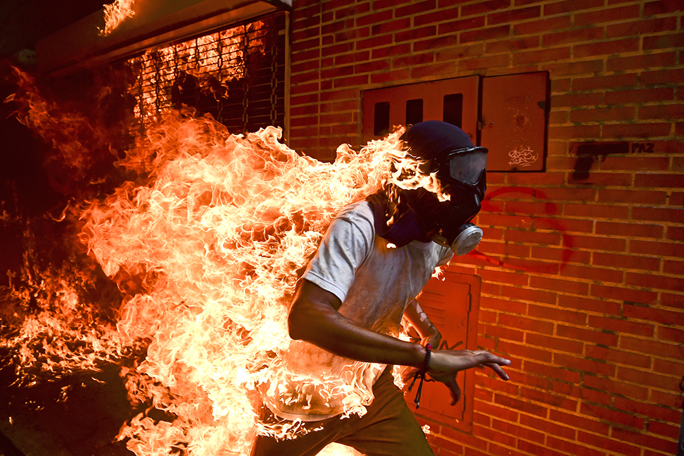 José Víctor Salazar Balza (28) catches fire amid violent clashes with riot police during a protest against President Nicolas Maduro, in Caracas, Venezuela.